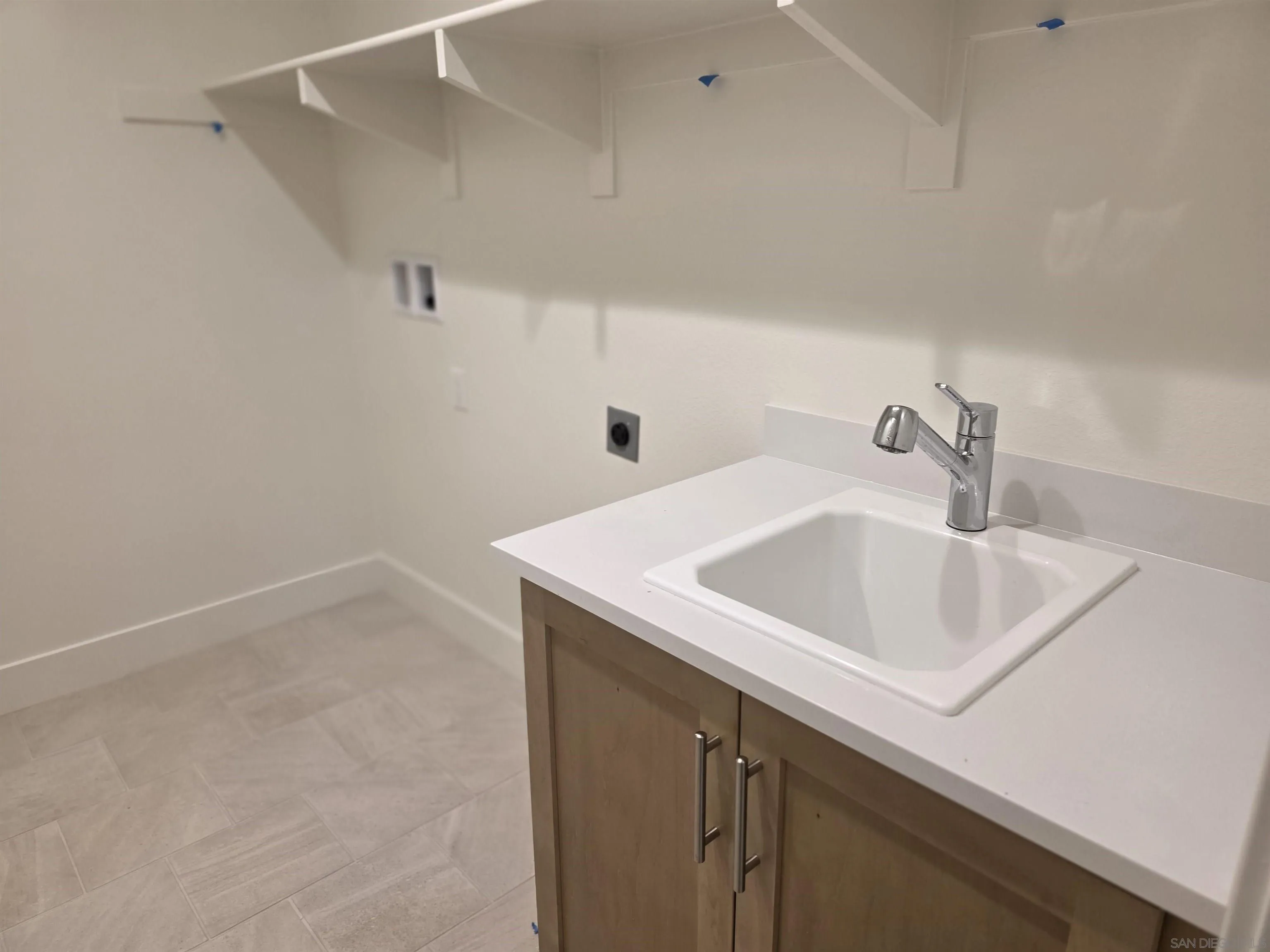 3501 Butler Place Escondido, CA 92027 - Photo 13 of 15 Large Laundry Room with sink and shelving