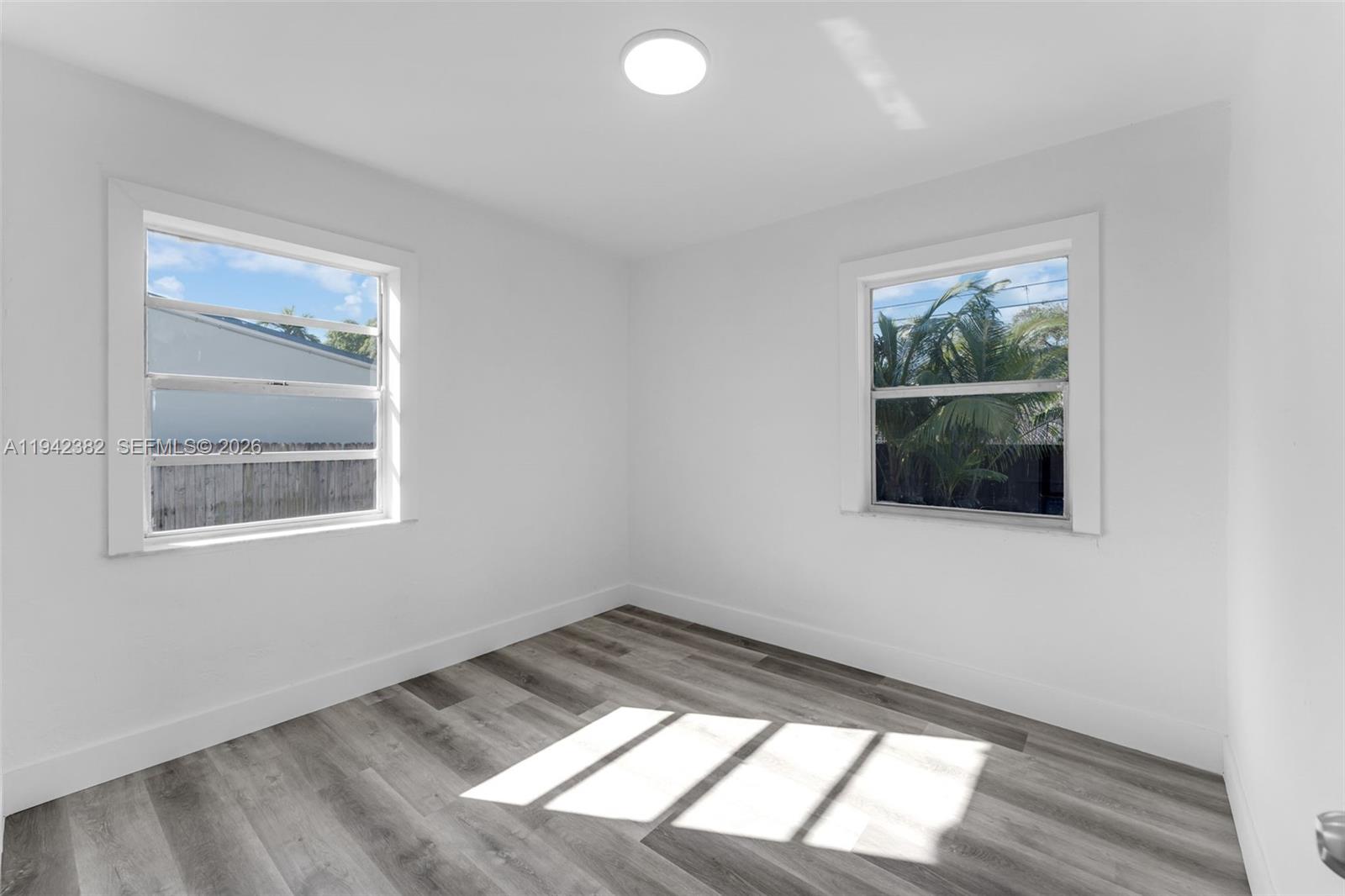 358 Pine Court Miami Springs, FL 33166 - Photo 12 of 24 an empty room with a window