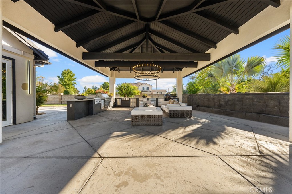 6069 Cannich Road Riverside, CA 92507 - Photo 12 of 75 a view of patio with table and chairs potted plants