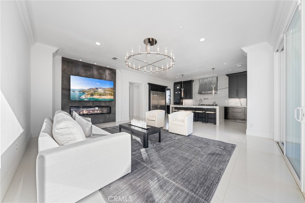 6069 Cannich Road Riverside, CA 92507 - Photo 35 of 75 a living room with furniture a flat screen tv and kitchen view