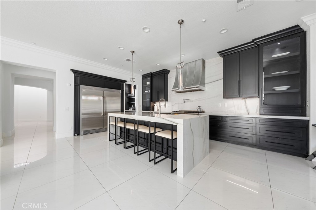 6069 Cannich Road Riverside, CA 92507 - Photo 38 of 75 a kitchen with kitchen island a sink stainless steel appliances and cabinets