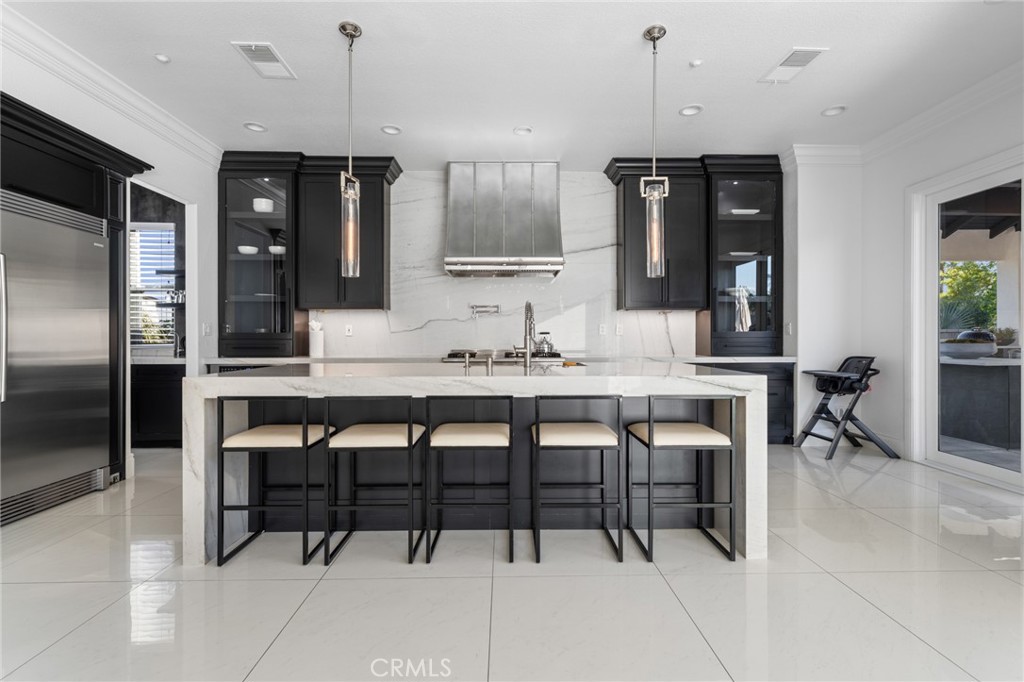 6069 Cannich Road Riverside, CA 92507 - Photo 39 of 75 a kitchen with granite countertop a table and chairs in it