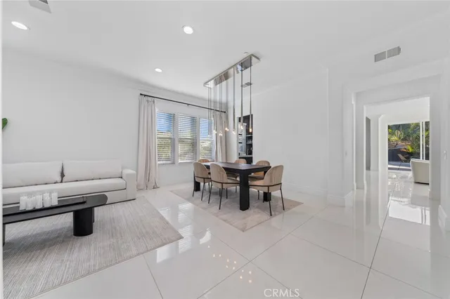 a bedroom with two beds and a chandelier
