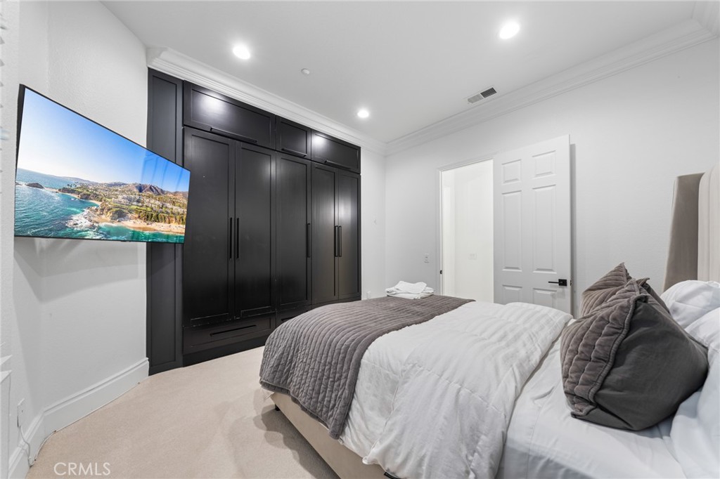 6069 Cannich Road Riverside, CA 92507 - Photo 44 of 75 a bedroom with a bed and a mirror