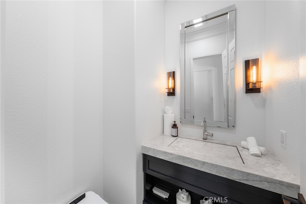 6069 Cannich Road Riverside, CA 92507 - Photo 45 of 75 a bathroom with a sink and a mirror