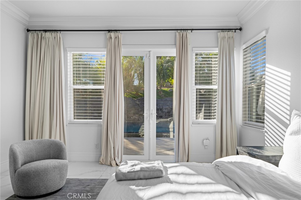 6069 Cannich Road Riverside, CA 92507 - Photo 52 of 75 a bedroom with furniture and a large window