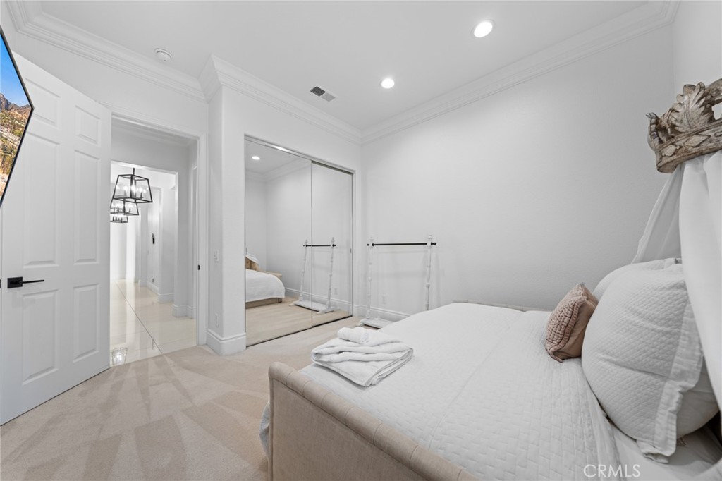 6069 Cannich Road Riverside, CA 92507 - Photo 54 of 75 a bedroom with a bed and a mirror