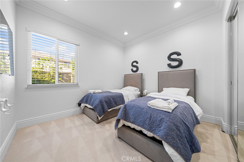 6069 Cannich Road Riverside, CA 92507 - Photo 55 of 75 a bedroom with two beds and a window