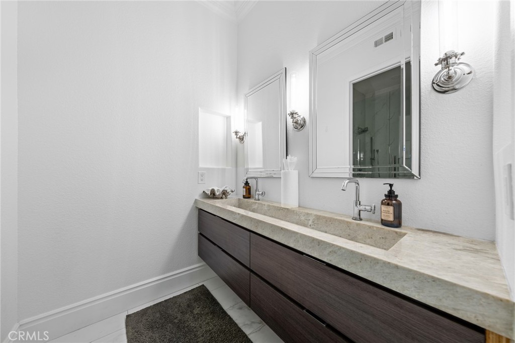 6069 Cannich Road Riverside, CA 92507 - Photo 57 of 75 a bathroom with a granite countertop sink and a mirror