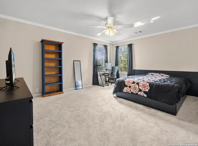 a bedroom with furniture and a flat screen tv