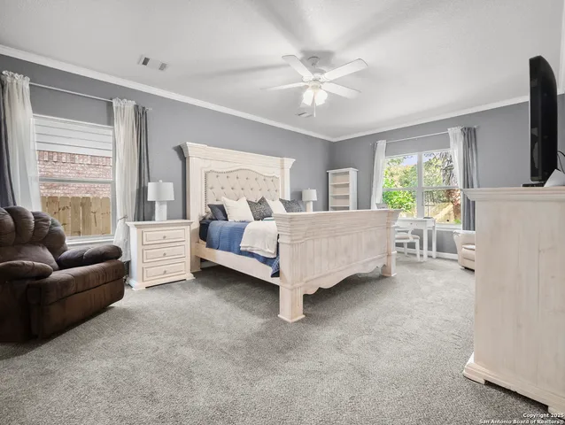 a bedroom with a bed couch and window