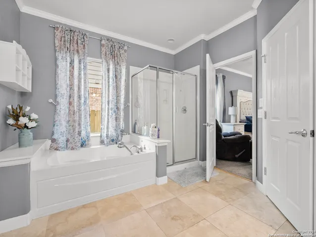 a spacious bedroom with a bed and a couch