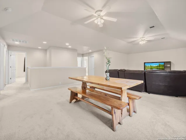 a room with pool table and windows