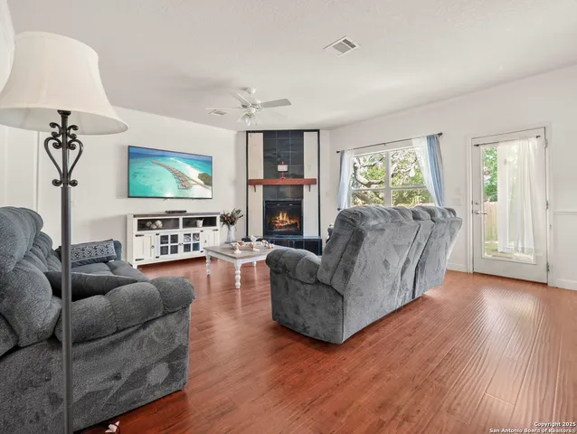 a living room with fireplace furniture and a flat screen tv