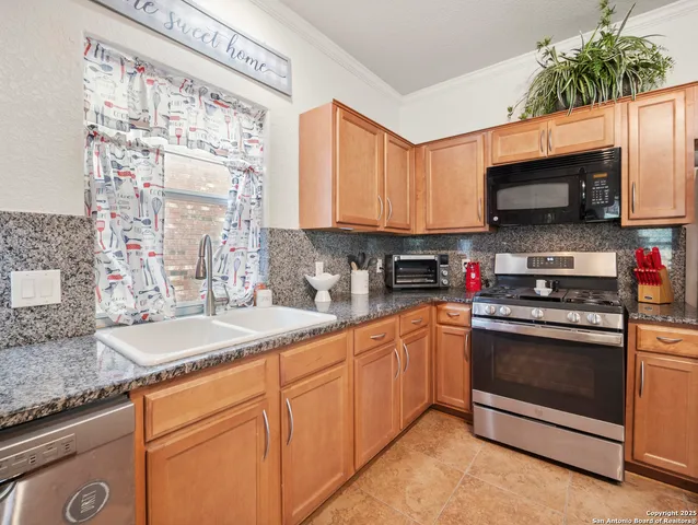 a kitchen with stainless steel appliances granite countertop a sink stove and microwave
