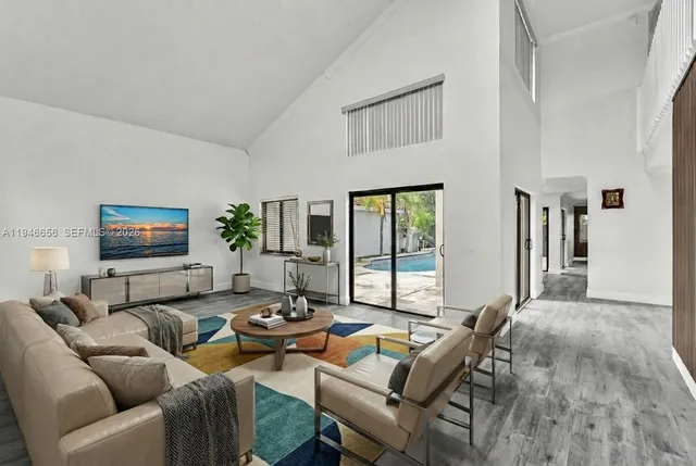 a view of a hallway with wooden floor and entryway