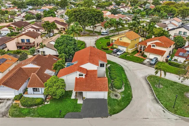 an aerial view of residential houses with outdoor space