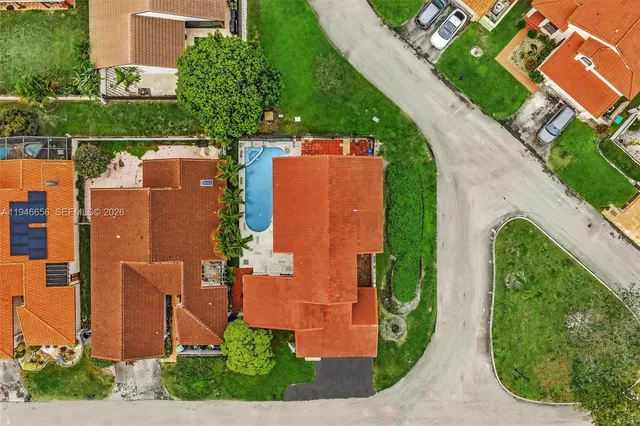an aerial view of residential houses with outdoor space and street view