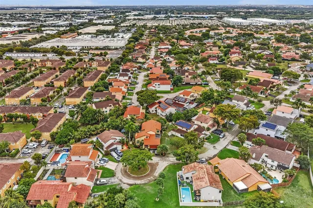 an aerial view of residential houses with outdoor space