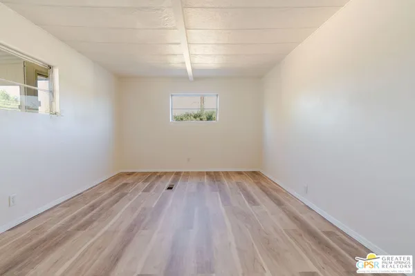 a view of a room with wooden floor