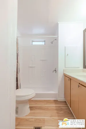 a bathroom with a toilet and a shower