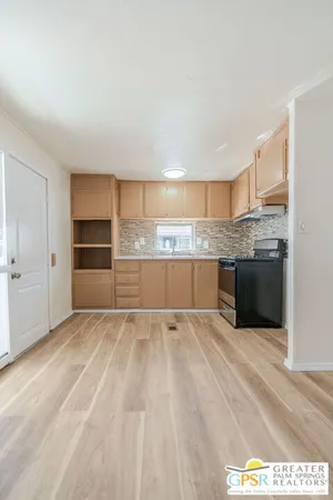 a view of a kitchen with a sink and a refrigerator