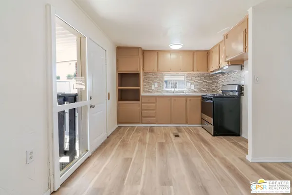 a view of wooden floor and windows in a room