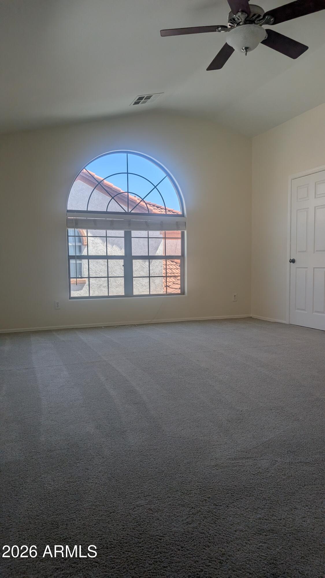 1453 South Sinova Avenue Gilbert, AZ 85296 - Photo 37 of 46 an empty room with a window and a ceiling fan