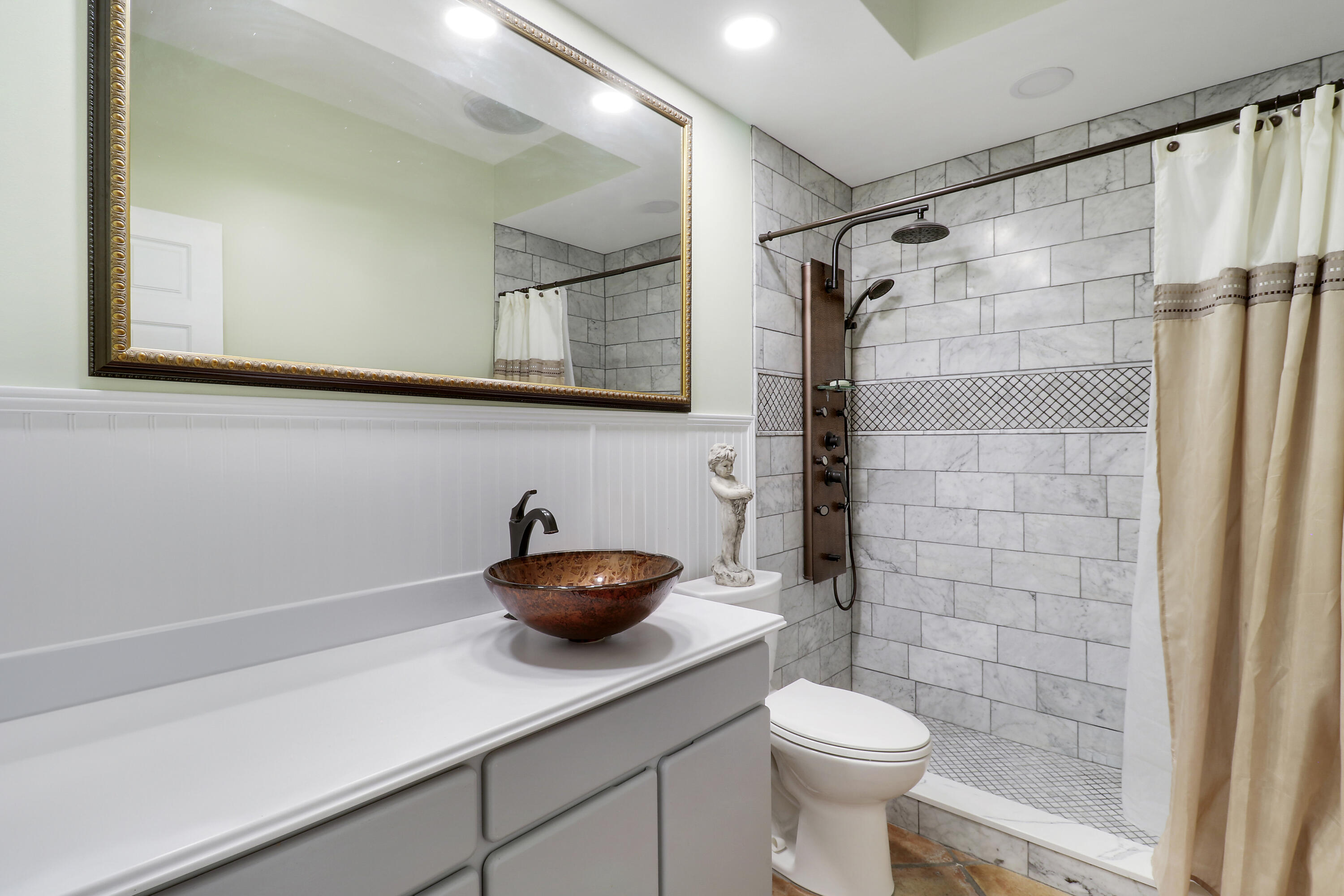 204 Chinook Lane Jupiter, FL 33458 - Photo 15 of 30 a bathroom with a granite countertop sink a toilet and a shower