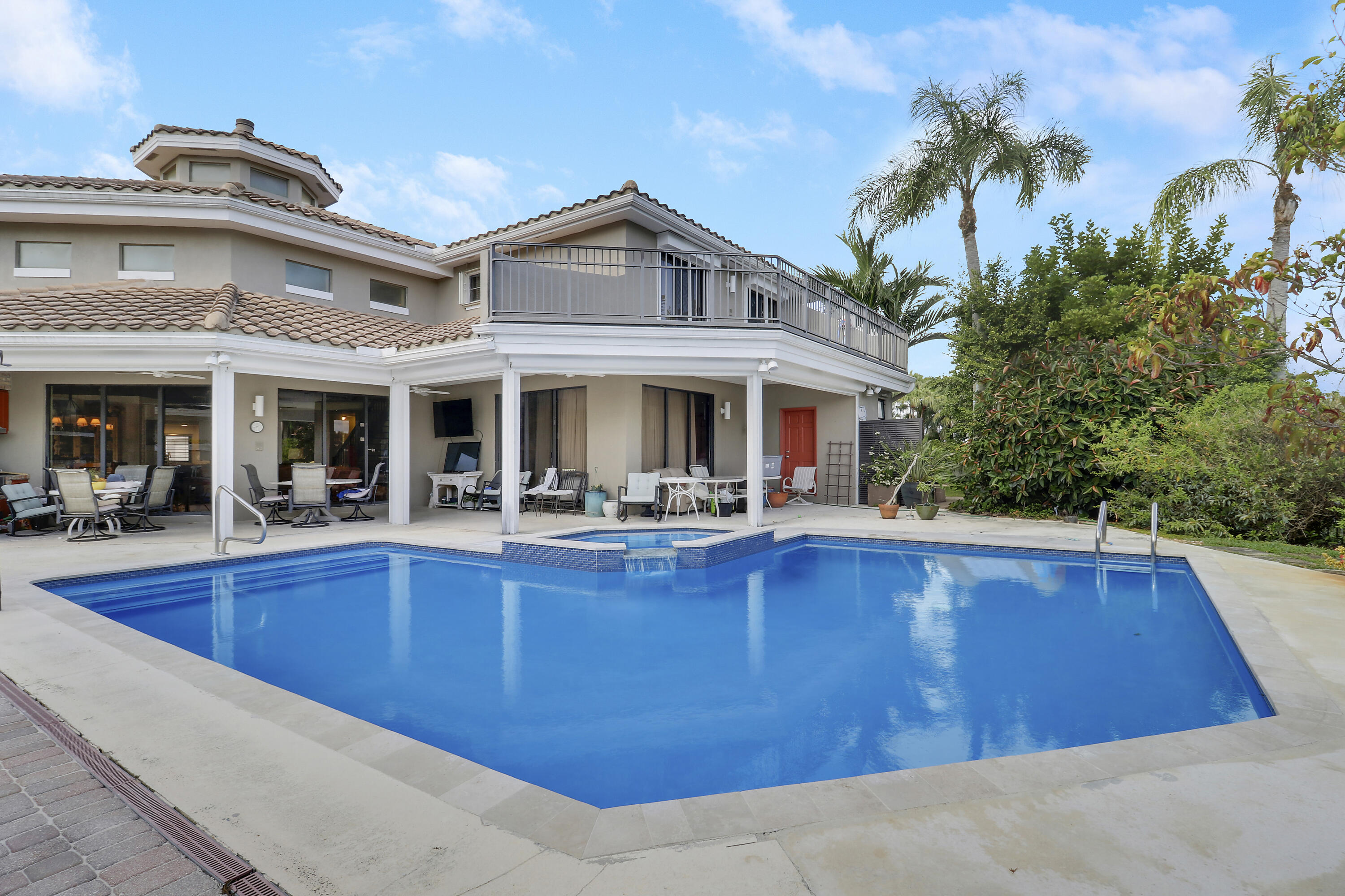 204 Chinook Lane Jupiter, FL 33458 - Photo 22 of 30 a view of a house with swimming pool and a porch