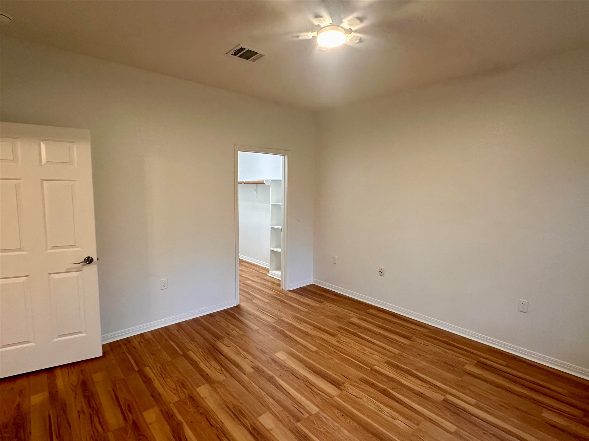 1122 Mansell Avenue Austin, TX 78721 - Photo 17 of 29 a view of an empty room with wooden floor