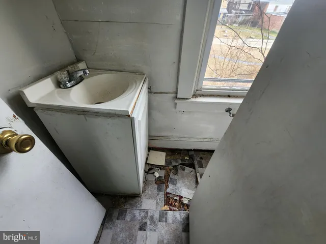 a bathroom with a toilet sink and window