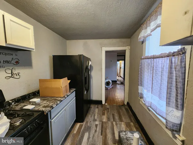 a kitchen with a stove and a refrigerator