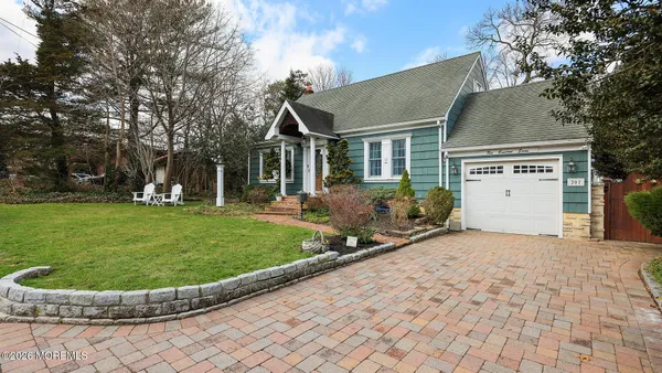 a view of a white house with a sink and a yard