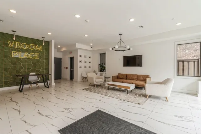 a living room with furniture and a chandelier