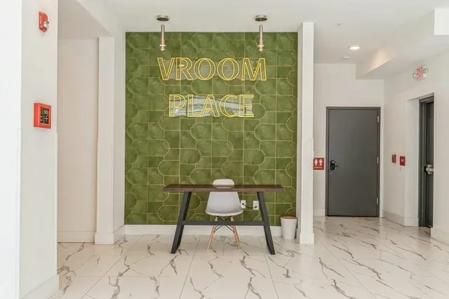 a view of a hallway with a door and chair