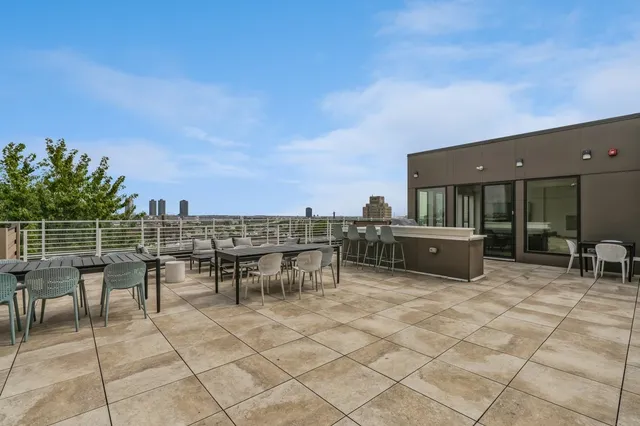 a view of a patio with dining table and chairs with wooden floor