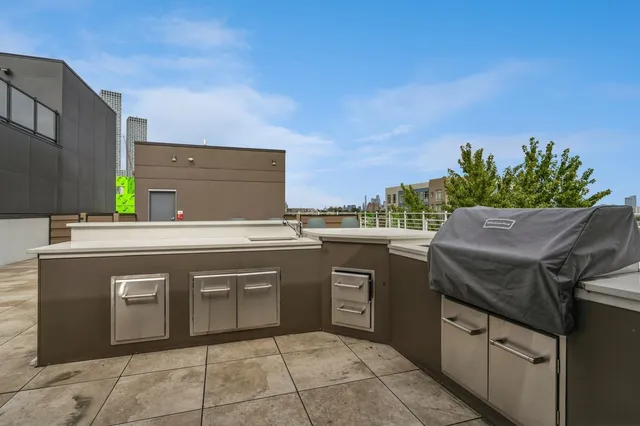 a view of kitchen with granite countertop stove top oven and sink
