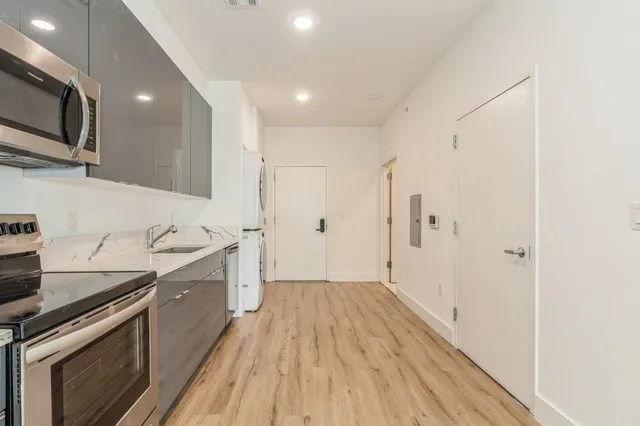 a kitchen with a sink a microwave and cabinets