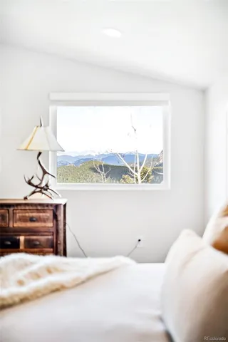 a bedroom with a bed and window