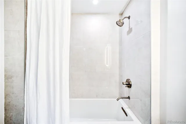 a bath tub sitting next to a white sink