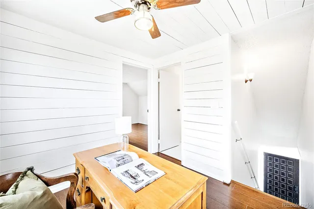 a view of a workspace with wooden floor and entryway