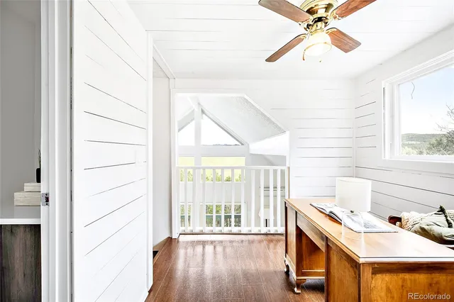 a view of a room with wooden floor and white walls