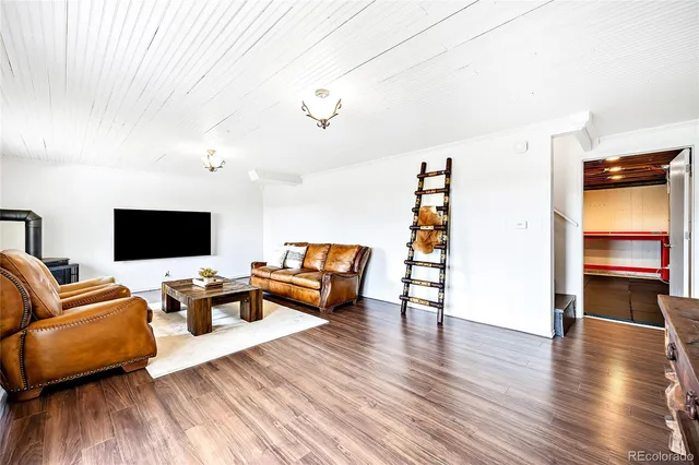 a living room with furniture and flat screen tv