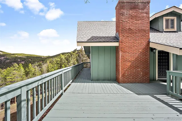 a view of a house with a tree in the background