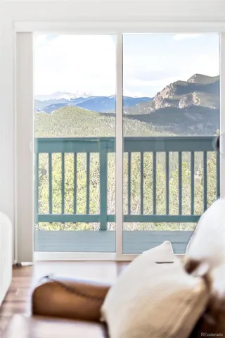 a bedroom with a bed and glass window