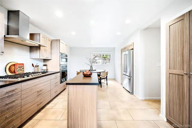 a kitchen with stainless steel appliances a refrigerator and a sink