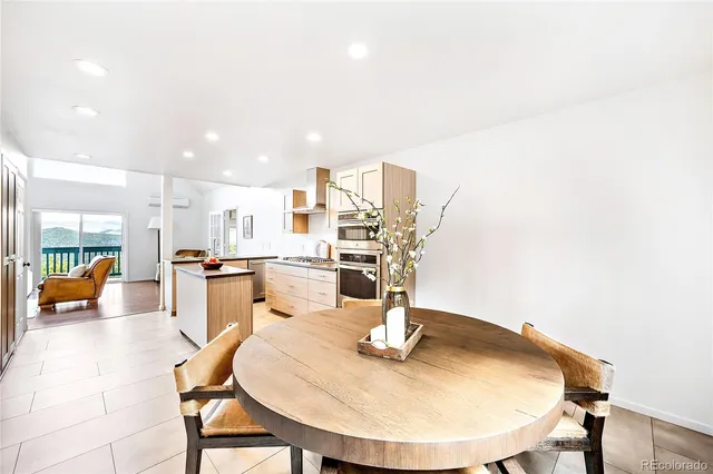 a dining room with a table and chairs