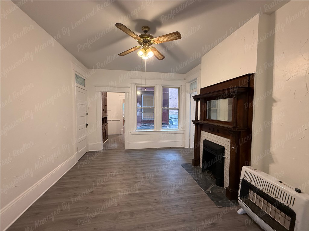 44 West High Street, Unit B Springfield, OH 45502 - Photo 14 of 31 This inviting living space features an elegant fireplace, perfect for cozy gatherings.