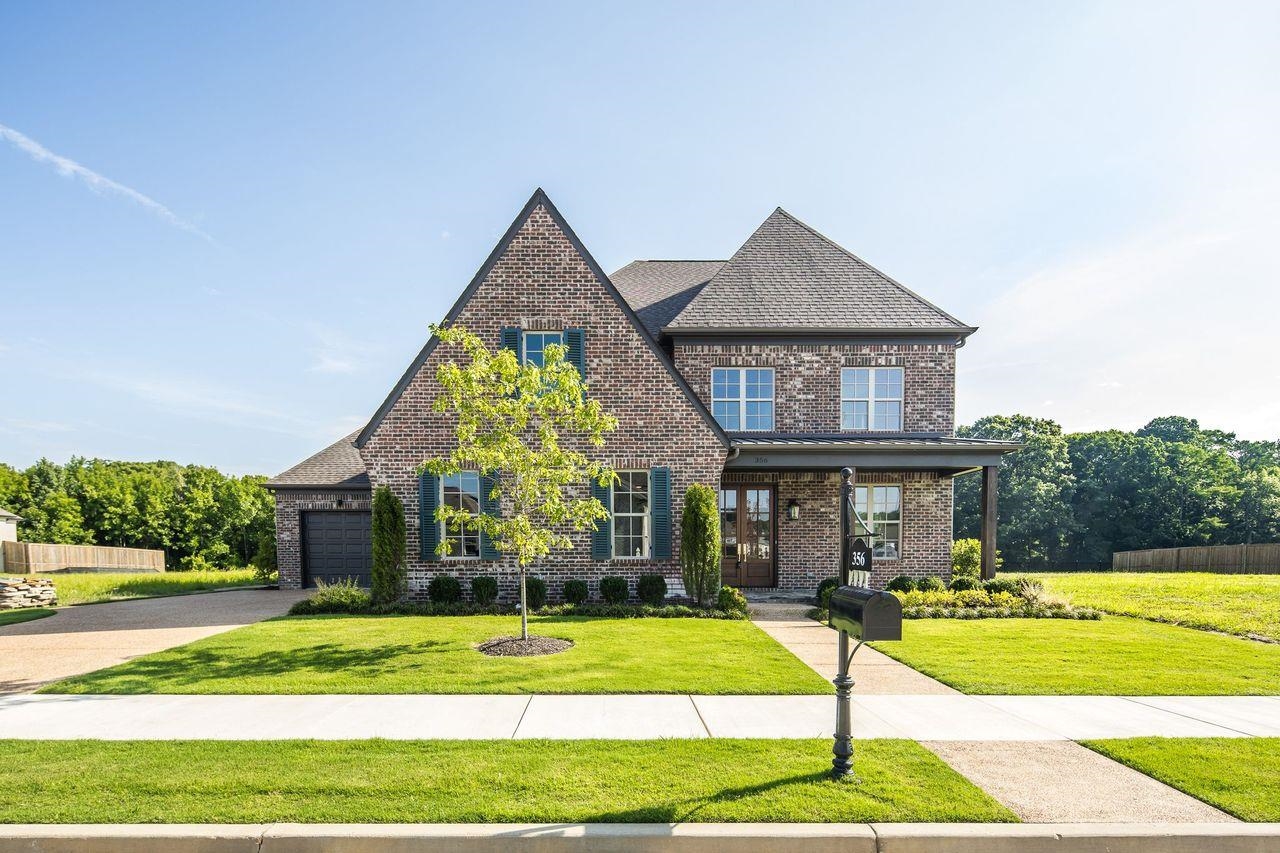 a front view of a house with swimming pool having outdoor seating